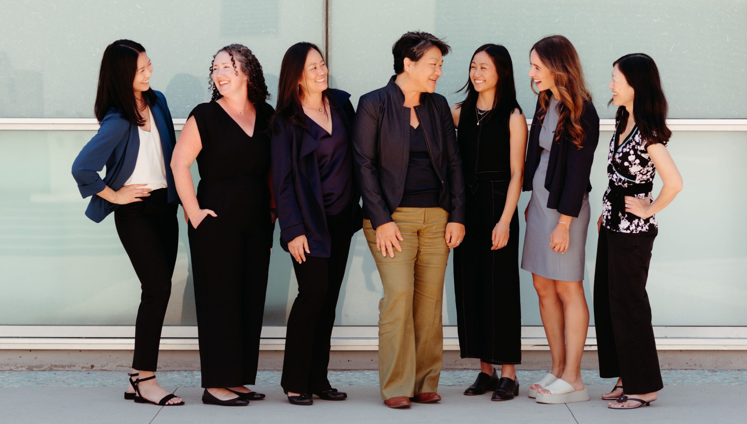Seven women smiling and laughing