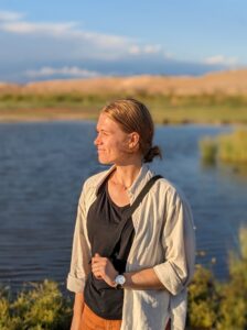 A woman at golden hour staring at the sunset