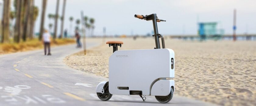 Honda Motocompacto electric scooter on a beach pathway