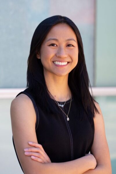 A woman with black hair smiling at the camera